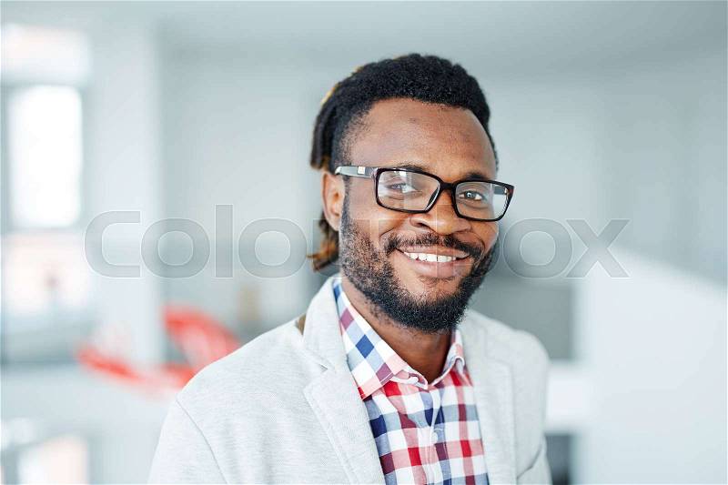 Successful businessman in eyeglasses looking at camera, stock photo