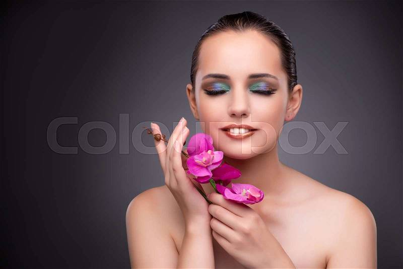 Beautiful woman with orchid flower, stock photo