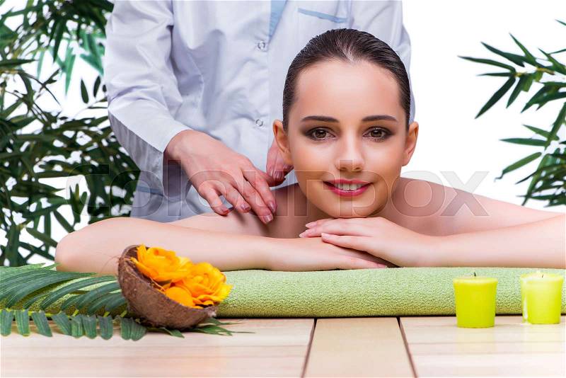 Woman during massage session in spa salon, stock photo
