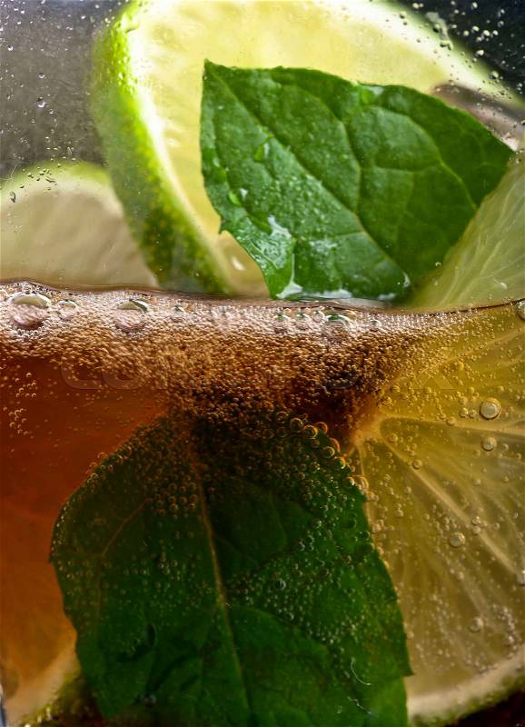 cola with lime , ice and peppermint leaves , stock photo
