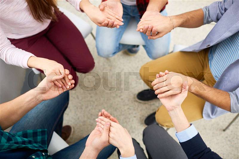 Human hands held together during group psychotherapy, stock photo