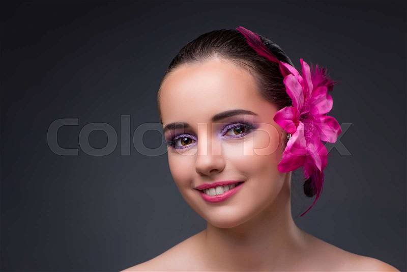 Young beautiful woman with orchid flower, stock photo
