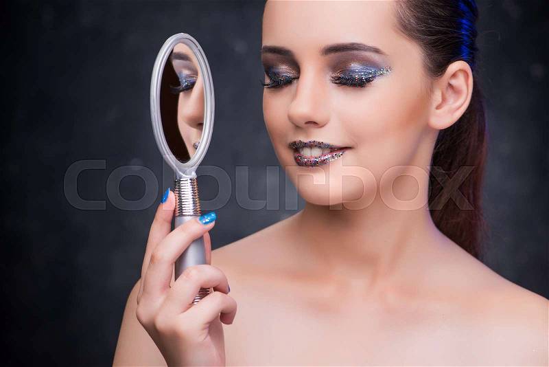 Young woman with small mirror in beauty concept, stock photo