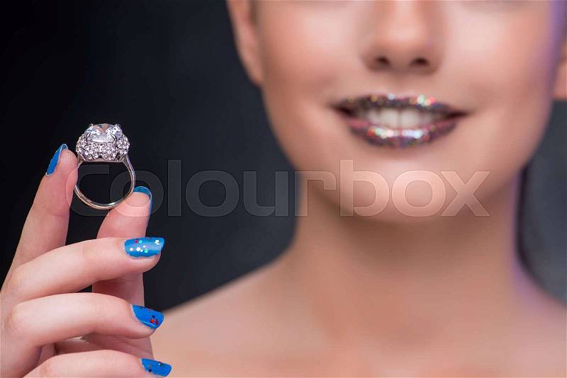 Young woman receiving proposal with diamond ring, stock photo