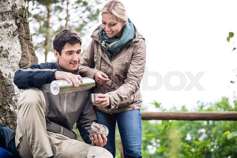 Young wanderers found a place to rest, eat and drink under trees, stock photo