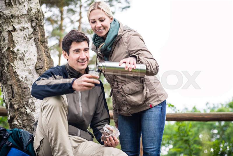 Young wanderers found a place to rest, eat and drink under trees, stock photo