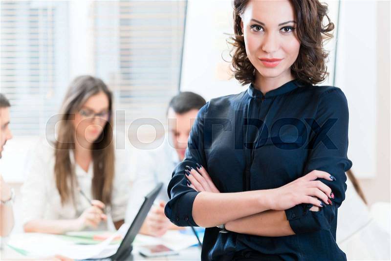 Manager with her team working in the office, stock photo