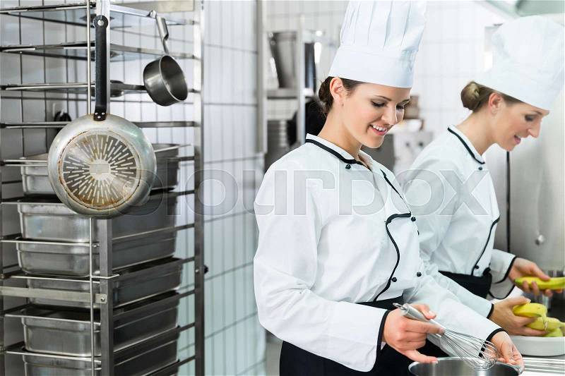 Canteen kitchen with chefs during service, stock photo