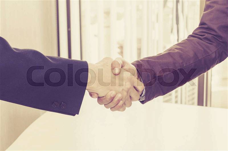 The two businessmen shake hands after successfully doing business, stock photo