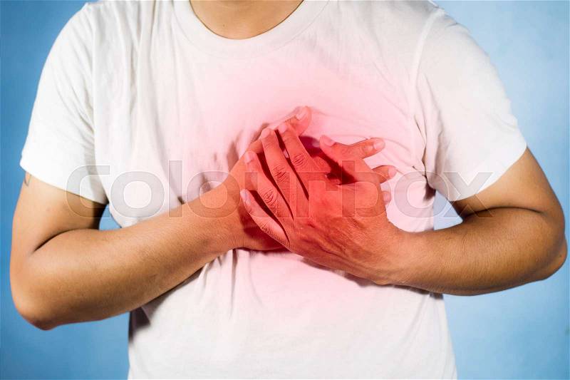 Asian man is clutching her chest / acute pain possible heart attack, stock photo