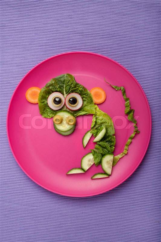Monkey made of vegetables on plate and fabric, stock photo