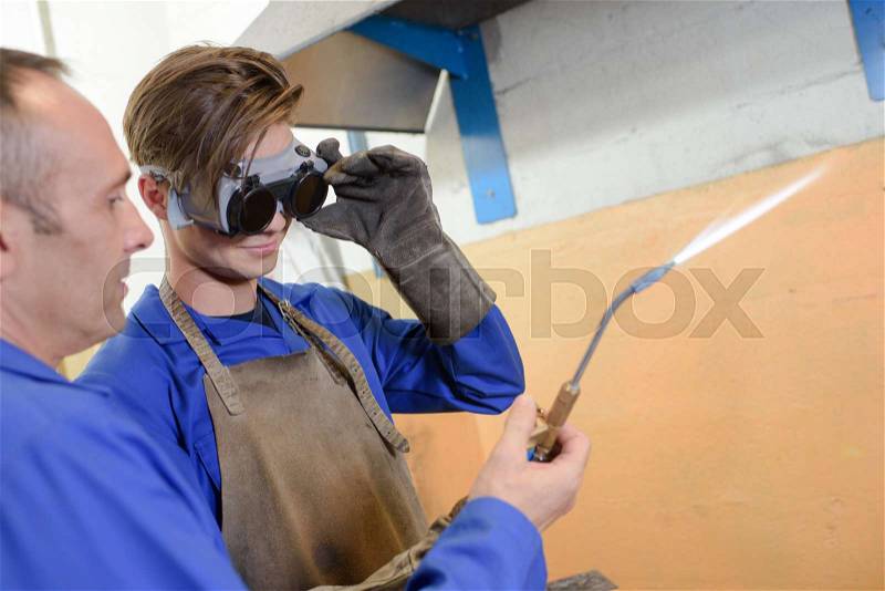 Two men with gas torch, stock photo