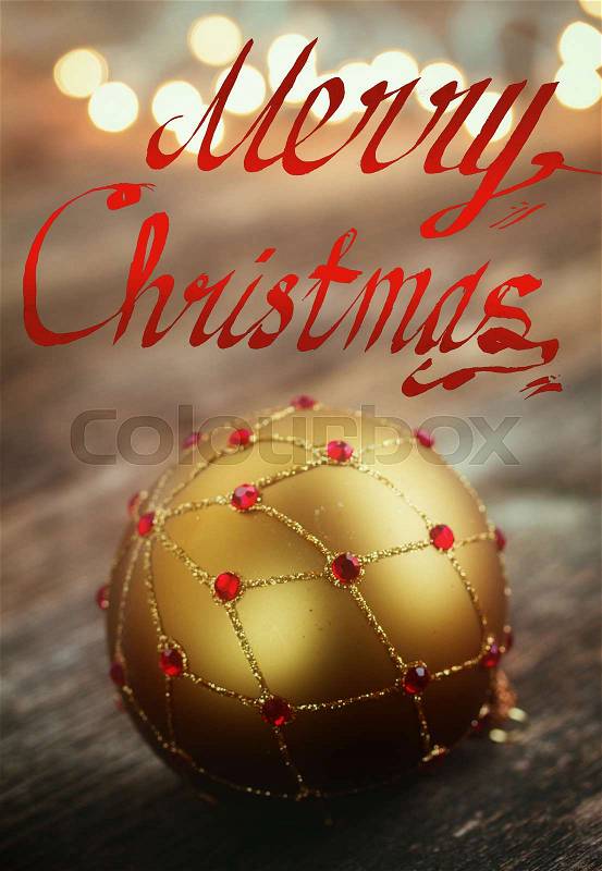 Merry Christmas letters and golden ball , christmas lights in background, retro toned, stock photo
