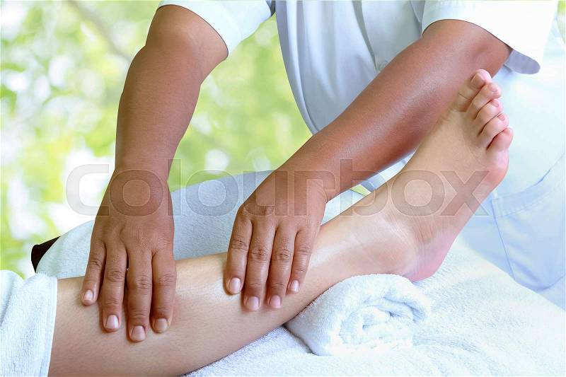 Masseur doing reflexology,Thai foot massage in spa on nature background, stock photo