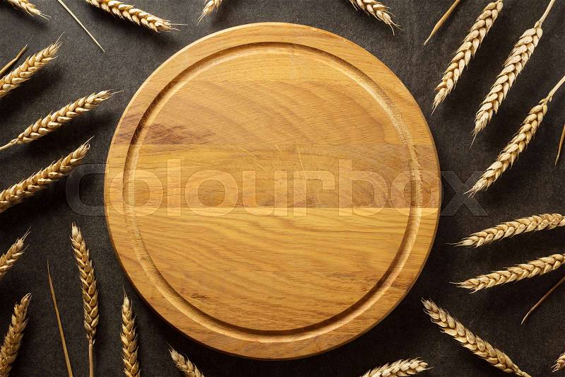 Ears of wheat on black background texture, stock photo