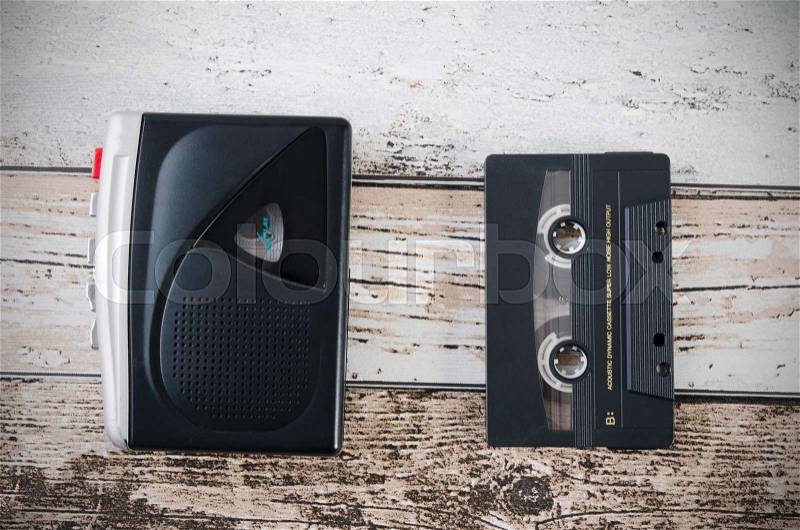 Old tape player, recorder and casette on wooden background. Top view composition, stock photo