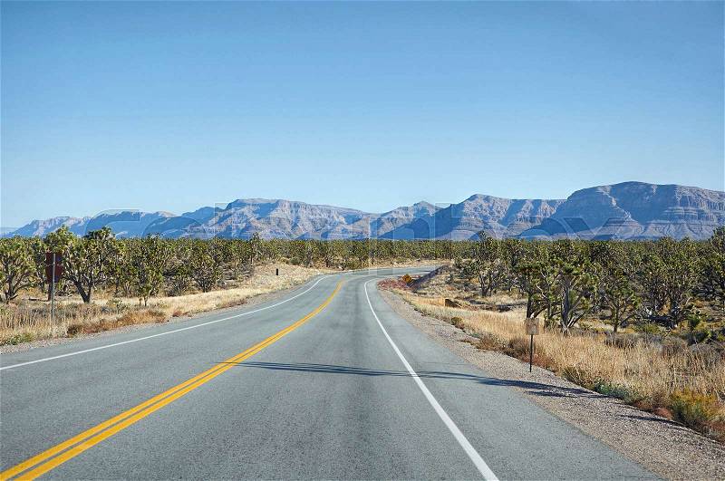 Highway makes right turn in Nevada desert, stock photo