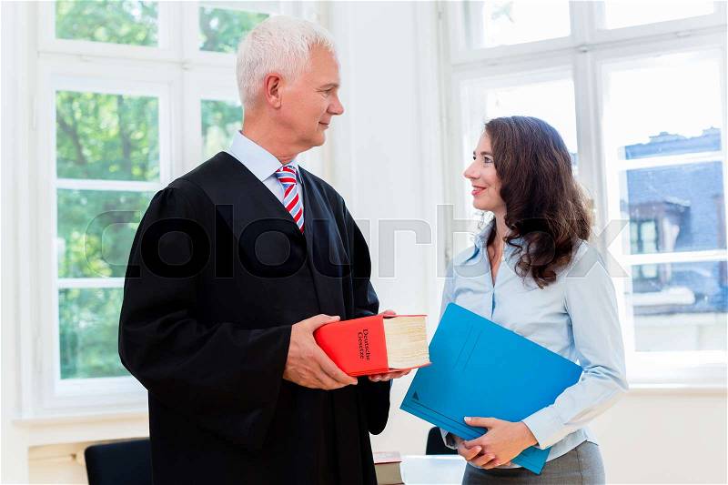 Lawyer and paralegal in their law office, stock photo