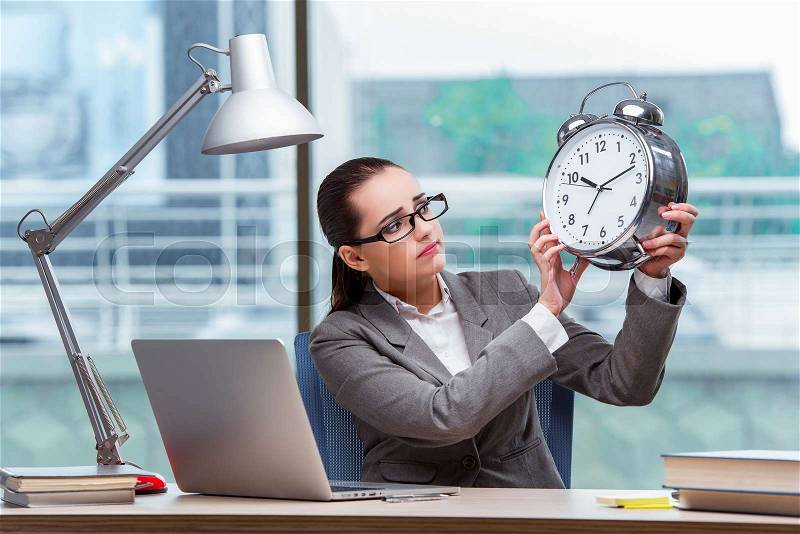 Businesswoman failing to meet her deadlines in business concept, stock photo