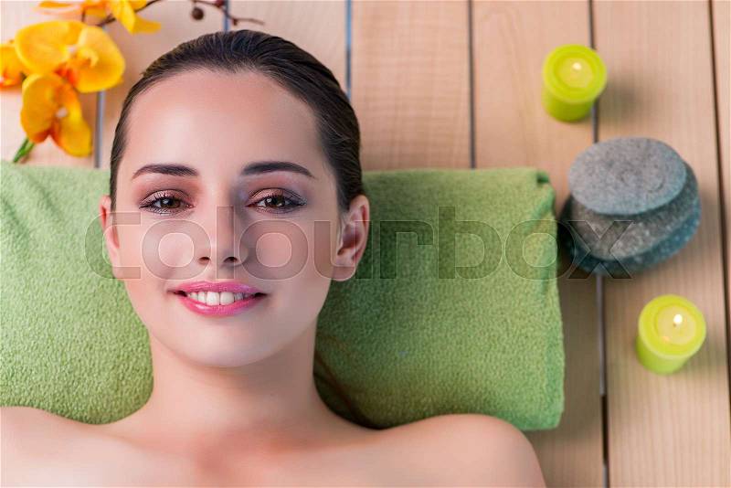 Young beautiful woman during spa procedure, stock photo