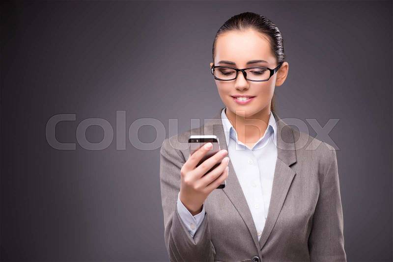 Businesswoman texting and sending text messages, stock photo