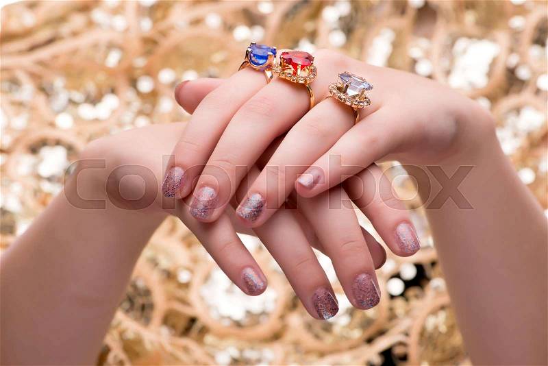 Woman showing off her jewellery rings in fashion concept, stock photo