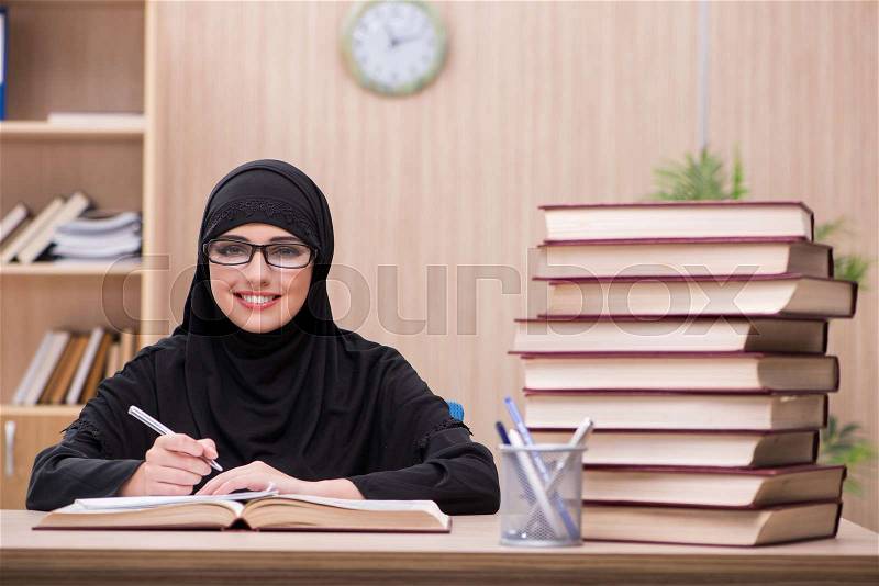 Woman muslim student preparing for exams, stock photo