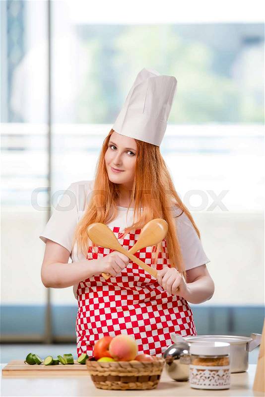 Redhead cook working in the kitchen, stock photo