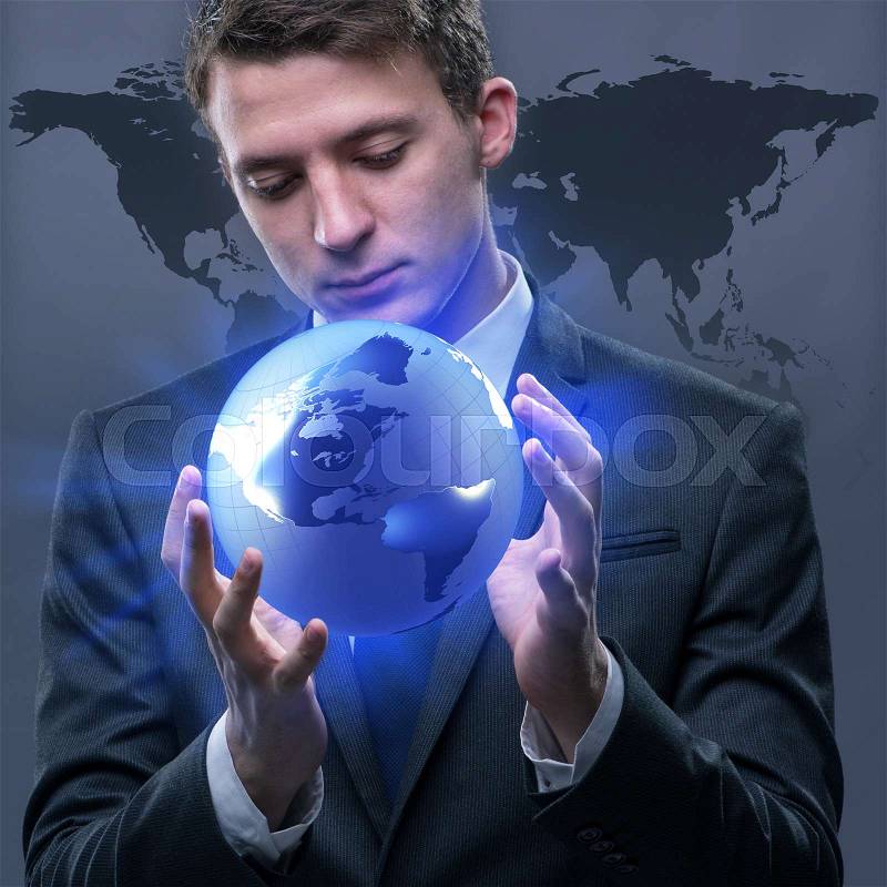 Businessman holding globe in global business concept, stock photo