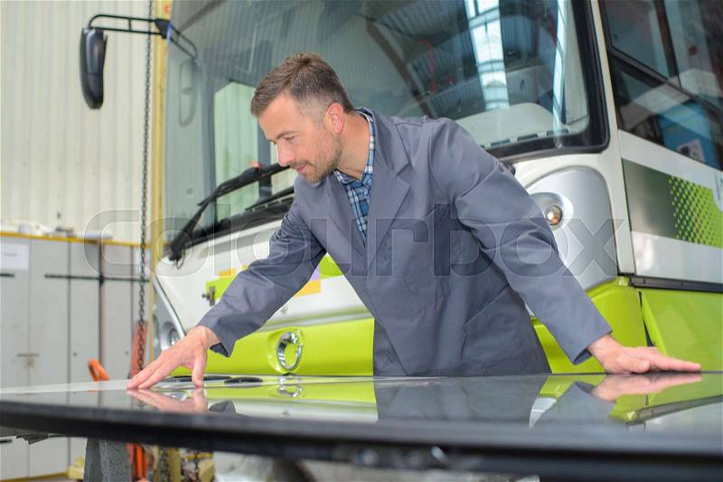 Mechanic working on a bus, stock photo