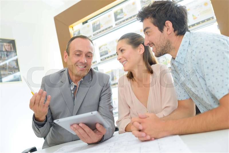 Couple in meeting with estate agent, stock photo