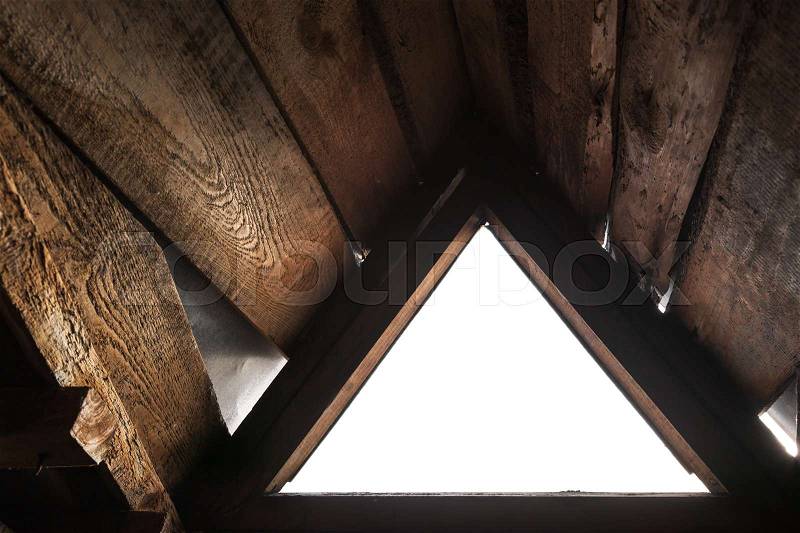 Empty triangle window with white background in old grunge wooden interior, stock photo