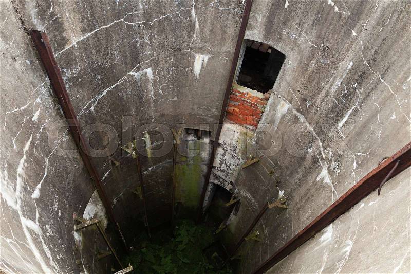 Abandoned military silo. Grunge concrete tunnel interior, stock photo
