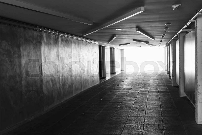 Underpass. Dark abstract underground tunnel interior with glowing end, stock photo