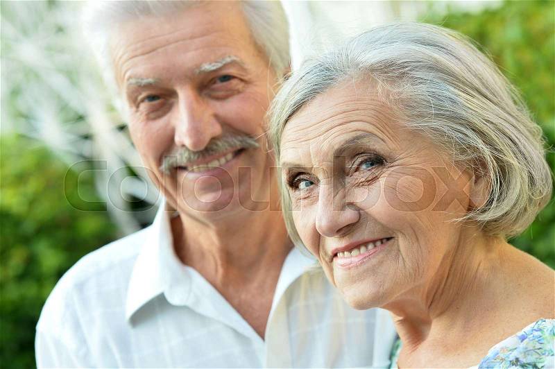 Portrait of a nice mature couple in spring park, stock photo