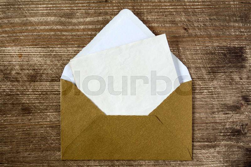 Golden envelope with blank letter for your message, stock photo
