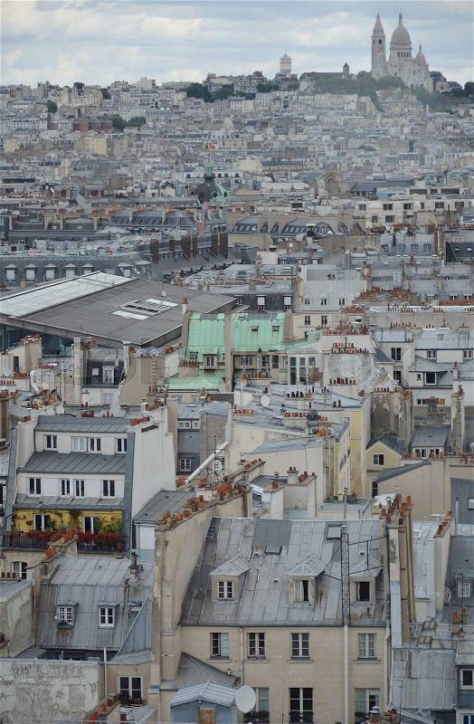 Overlooking Paris rooftops and houses against Sacre-Coeur, stock photo
