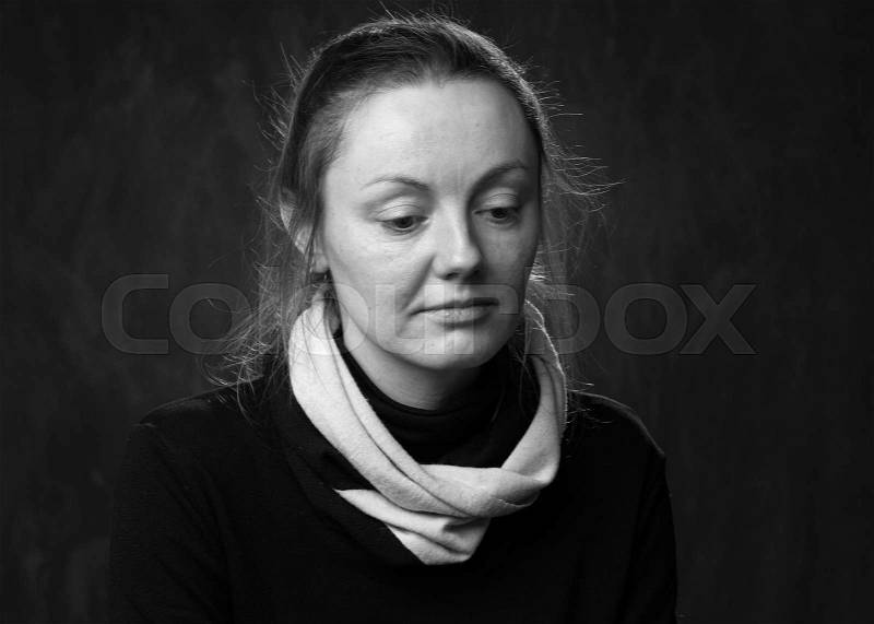 Close up portrait of a sad woman looking down, black and white, stock photo