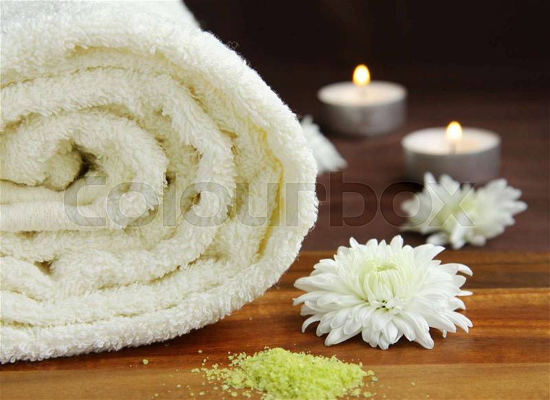 White towel, candles and flowers - spa concept, stock photo