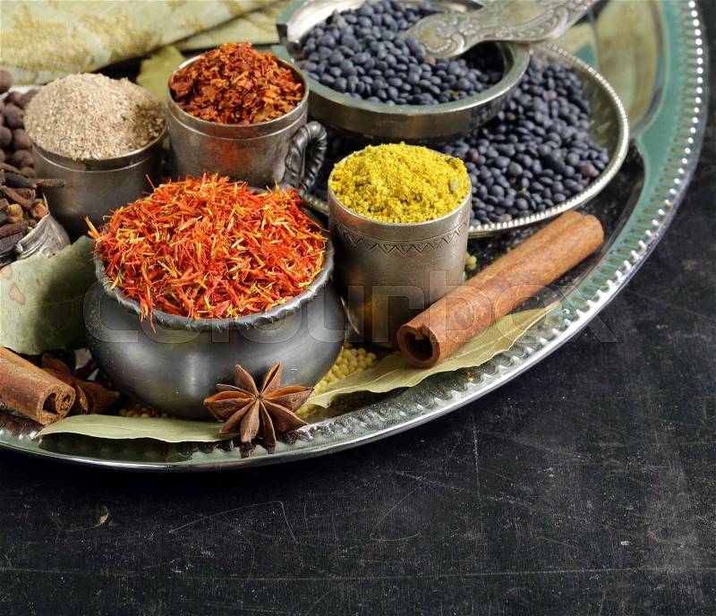 Assorted spices (saffron, pepper, turmeric, cinnamon), stock photo