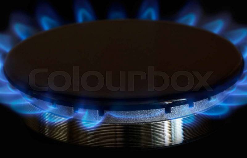 Gas burner is lit on the kitchen, stock photo