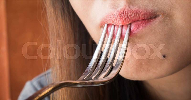 Close up women mouth eating with \Spoon in restaurant, stock photo