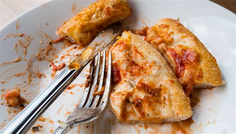 Waste food of pizza after eat with spoon, stock photo