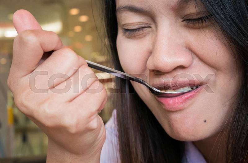 Close up women mouth eating with Spoon in restaurant, stock photo