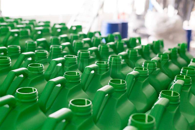 Empty plastic cans green colour for liquids. Concept: Manufacturing, stock photo