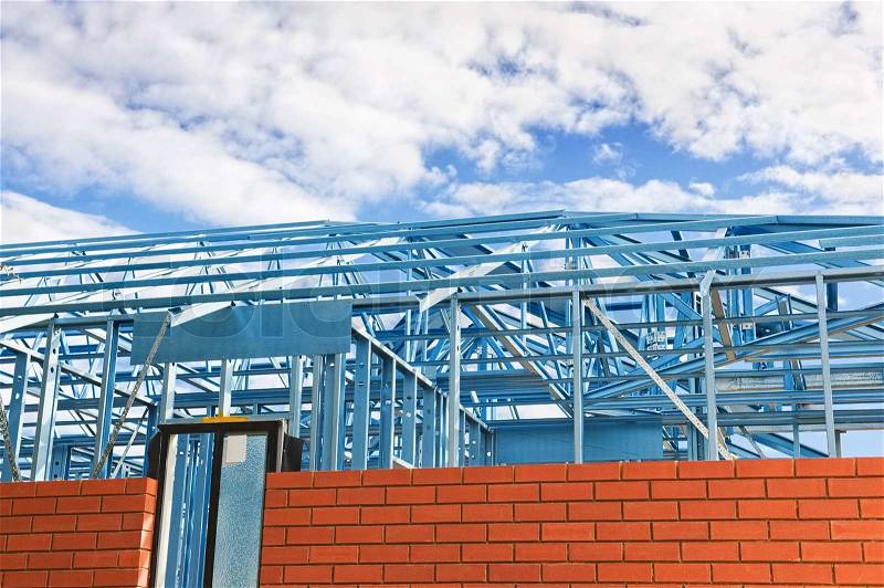 New residential construction home metal framing against the blue sky, stock photo