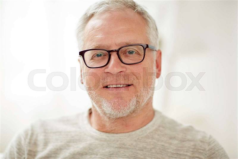 Old age, vision and people concept - close up of smiling senior man in glasses, stock photo