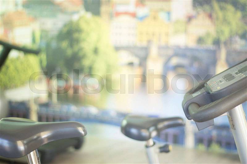 Gym bike exercise cycle machine for static indoor cycling in fitness studio, stock photo