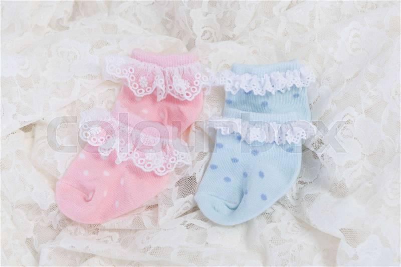 Baby socks for new born baby on Wedding lace background, stock photo