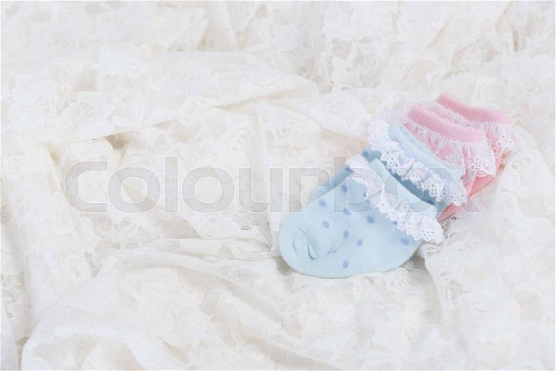 Baby socks for new born baby on Wedding lace background, stock photo